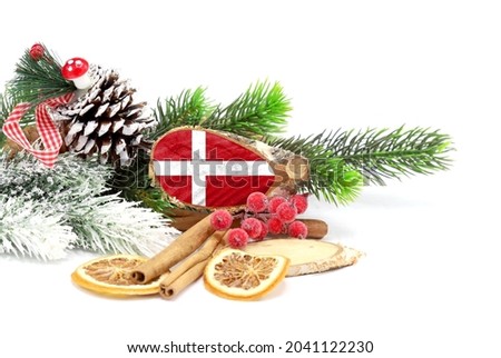 New Year and Christmas 2022, holiday decorations isolated on white background with the flag of Denmark engraved on a tree cut.