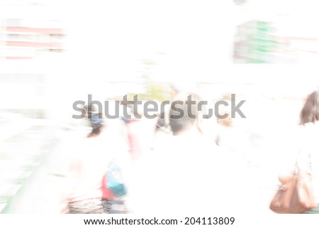 City commuters. High key blurred image of workers going back home after work. Unrecognizable faces, bleached effect.