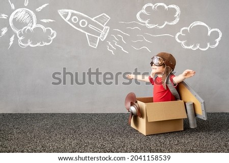 Child pretend to be pilot. Kid having fun at home. Happy child dreaming about travel. Funny kid playing. Summer vacation and travel concept Royalty-Free Stock Photo #2041158539