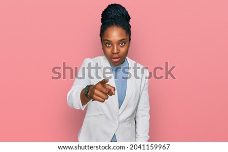 Young african american woman wearing business clothes pointing displeased and frustrated to the camera, angry and furious with you 