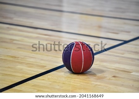 Basketball ball on wooden court background in the gym