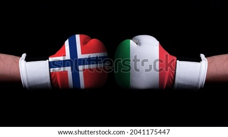 Two hands of wearing boxing gloves with Italy and Norway flag. Boxing competition concept. Confrontation between two countries