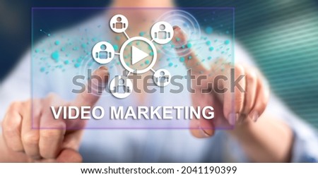 Woman touching a video marketing concept on a touch screen with her fingers