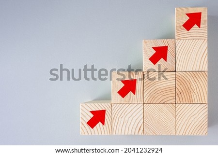 Wooden block staircase with arrow icon, business planning concept. economic growth, success, achievement of goals and objectives.
