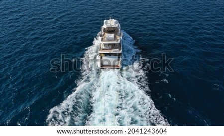 Aerial drone photo of luxury yacht cruising in deep blue Mediterranean sea