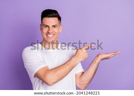 Photo of young guy happy positive smile point finger product ad offer suggest sale isolated over violet color background