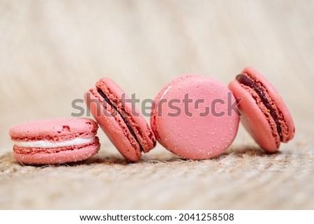 French pink macarons on beige background