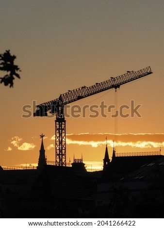 construction crane on the background of the Kremlin towers late in the evening at sunset