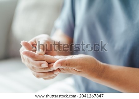 Woman suffering from hand and finger joint pain​.​ Causes of rheumatoid arthritis, carpal tunnel syndrome, gout. Health care and medical concept. Royalty-Free Stock Photo #2041267847