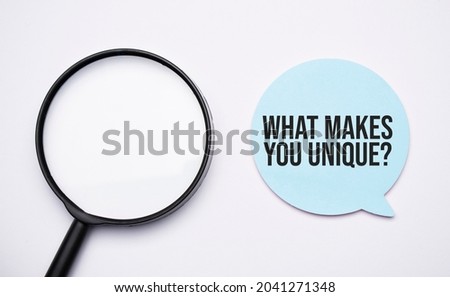 What makes you unique speech bubble and black magnifier isolated on the yellow background.