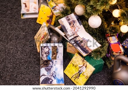 photobook, album and weights for sports near the Christmas tree as a gift holiday