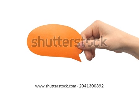 Orange round speech bubble in hand isolated on a white background. Giving feedback, communication concept. Empty cardboard text box mockup photo