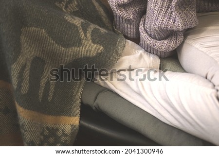 Woman in warm clothes trying to getting warmer, cold hands, winter and autumn season concept
