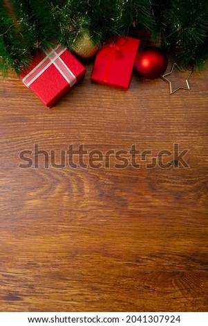 Composition of christmas decorations with presents, baubles and copy space on wooden background. christmas, tradition and celebration concept.