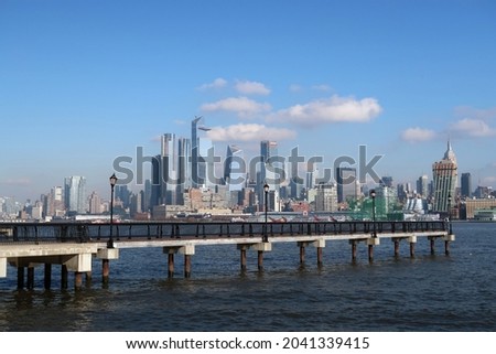 Modern pier in the foreground and the city skyline in the distance. 
