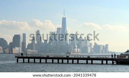 Modern pier in the foreground and the city skyline in the distance. 