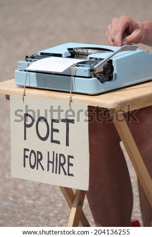 coronavirus covid-19 arts no work lockdown concept, Poet for hire with typewriter, many people angry after government retrain campaign aimed at people in the arts, music, creative industry 