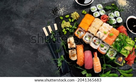 Sushi and roll set on dark background. Traditional food concept. Top view, flat lay, copy space