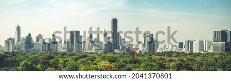 Public park and high-rise buildings cityscape in metropolis city center . Green environment city and downtown business district in panoramic view . Royalty-Free Stock Photo #2041370801