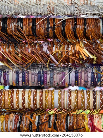 Rows of different leather bracelets on the market vertical