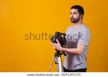 Young boy with a cinematographic camera. Cinema director