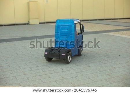 Children's electric car. A small truck for a child. A blue car driven by a preschooler.