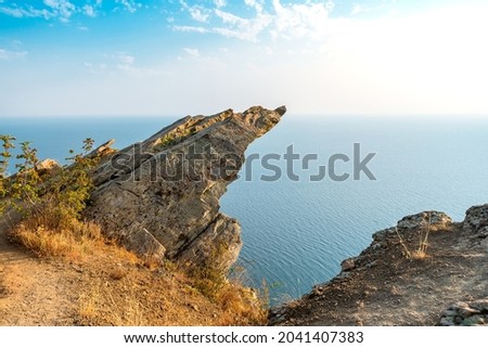 A sheer cliff above the sea against the sky. Minimalist landscape
