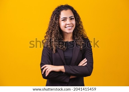 Afro Business Woman. Confident black woman in suit posing with folded arms on yellow background, horizontal banner, wide long shot, panorama Royalty-Free Stock Photo #2041415459