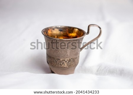 Antique metal cup for coffee on a white background
