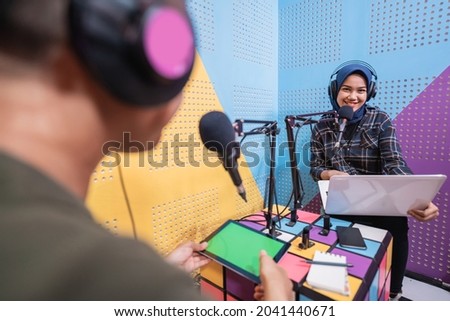 man and women discussing on live streaming during podcast