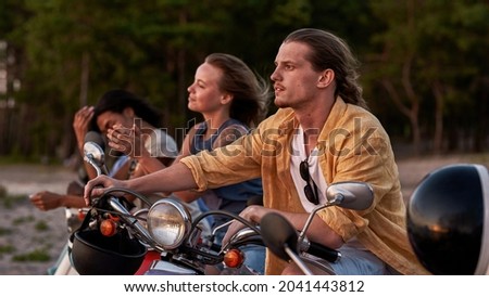 Caucasian young guy, motorcycle rider looking away, spending time together with his friends outside the city. Friendship, nature, weekend concept. Web Banner