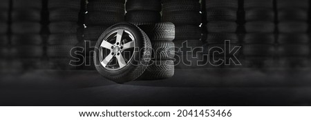 Car tires with a great profile in the car repair shop - warehouse Stock Royalty-Free Stock Photo #2041453466