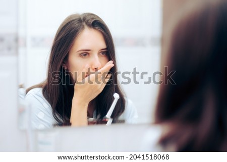 
Woman Holding Toothbrush Having a Toothache Looking in the Mirror. Young adult suffering from sore gums, gingivitis and other untreated dental health problems
 Royalty-Free Stock Photo #2041518068