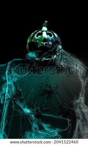 Halloween pumpkin scary minimal futuristic arrangement. Spiders crawling on terrifying web. Creepy dark background