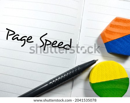 Business concept.Text Page Speed writing on notebook with pen and wooden block.