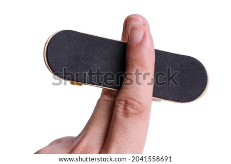 Isolated plays with a fingerboard. Man playing fingerboard on white background. clipping path.