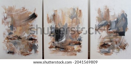 Three contemporary abstract paintings on the art studio. Nonfigurative abstract paintings of the same artistic series with colorful stains and strong brush texture. Royalty-Free Stock Photo #2041569809