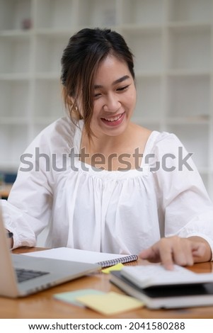 Photo of gorgeous secretary working at office. she sitting at the wooden desk
