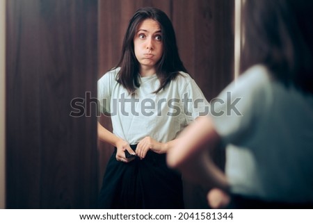 
Woman Trying on Pants that Don’t Fit Her Well. Girl in fitting room changing from tight clothes in wrong size
 Royalty-Free Stock Photo #2041581344