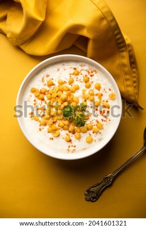 Boondi raita is a North Indian side dish variety made with spiced yogurt and boondi or crisp fried gram flour balls Royalty-Free Stock Photo #2041601321