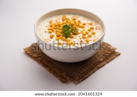 Boondi raita is a North Indian side dish variety made with spiced yogurt and boondi or crisp fried gram flour balls Royalty-Free Stock Photo #2041601324