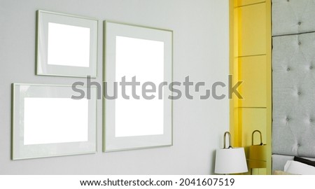 three different size of blank picture frames mockup on white wall background in the bedroom