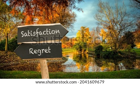 Street Sign the Direction Way to Satisfaction versus Regret Royalty-Free Stock Photo #2041609679