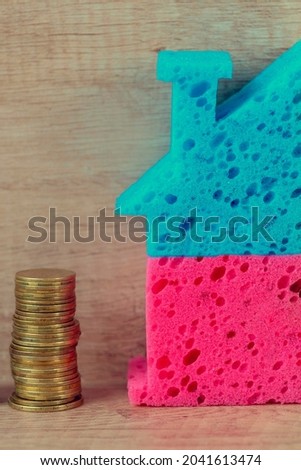 House with coins. Concept purchase, rent of housing, The rise in lodging prices, Investing in housing, habitation price, Real estate investment. Copyspace