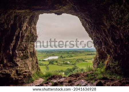 View from a cave on a beautiful scenery. Cloudy sky. Natural frame concept