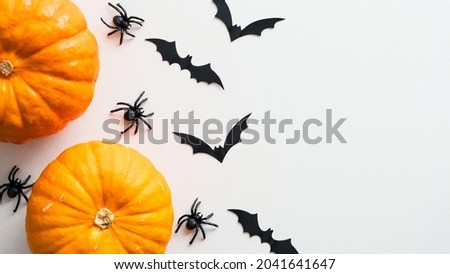 Happy Halloween holiday concept. Halloween decorations, pumpkins, spider, bats on white background. Flat lay, top view.