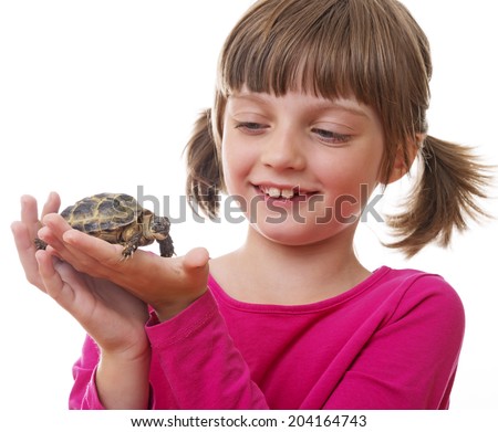  little girl holding a pet turtle