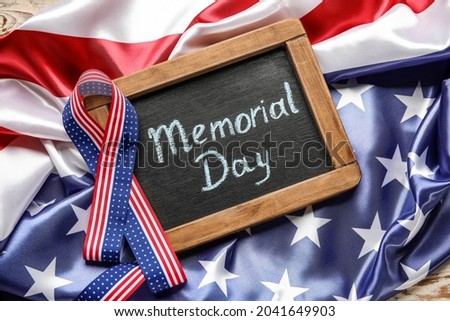 Chalkboard with text MEMORIAL DAY, ribbon and USA flag