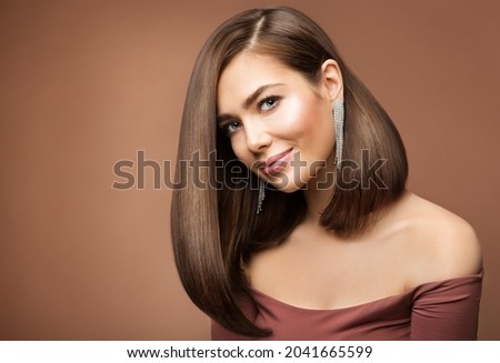 Woman Long Bob Haircut. Smiling Beauty Model with Brown Shiny Straight Hairstyle looking at Camera over brown Background Royalty-Free Stock Photo #2041665599