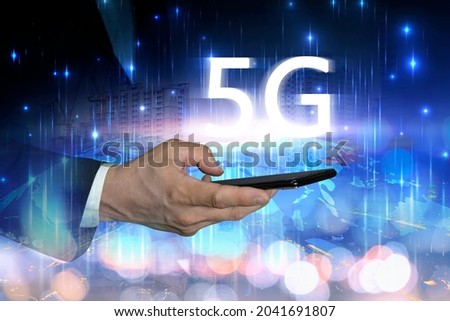 5 G wireless high speed Internet access. Businessman enters the high-speed world. Hand holding smart on line connection network and city at night with global communication. Royalty-Free Stock Photo #2041691807